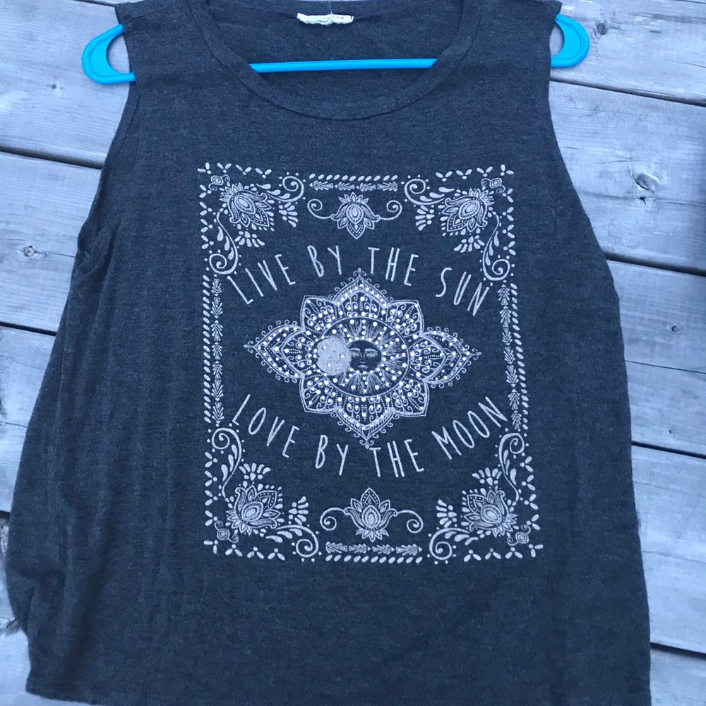 Tank top: “Live by the sun, love by the moon.”